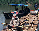 Loggers rafting cut logs of highly valued mahogany trees, Peru.