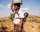 Woman carrying bucket of water