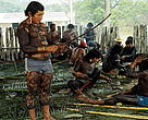 Kayapo Indians in the men's house making weapons. Amazon, Brazil
