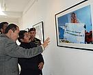Honorable Minister for Tourism and Civil Avaition, Mr Lokendra Bista Magar looking at the pictures during the exhibition.jpg