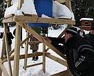 Members of the group study an automatic dispenser feeder equipped with timer in Sweden.