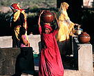 Women gathering water at a well in Rajasthan, India.