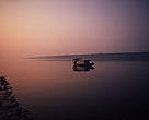 A fishing boat on the Dongtang Lake at dawn. Central Yangtze, Hunan Province, China.