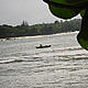 A man paddles his canoe along the coast © WWF / Moira Hough