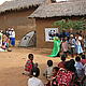 The volunteers performing the chameleon play to the villagers © WWF / Seraphine Wegner