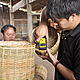 Staff is testing percentage of moisture of the rattan basket before going to another quality controlled stage © N.Promsouvanh