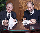 Monte Hummel, President of WWF-Canada, and John W. Weaver, President and CEO of Abitibi-Consolidated Inc., sign agreement on joint forestry conservation programme.