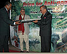 Handing over the papers at a ceremony