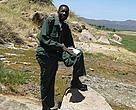 WWF Prince Bernhard Scholar, Absalom Shigwedha, in nature uniform and boots during a field identification and ecological monitoring safari in Tanzania's Lake Manyara National Park