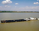 Heavy navigation threatens the Danube River ecosystem. Barge navigating along the Danube River, Slovakia.