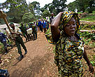 A grieving widow walks ahead of her husband's coffin at the funeral for the three slain rangers and five soldiers