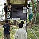 COMFISH staff work with villagers from Ban Muong Muan to nail down a sign board explaining village regulations.
© WWF Greater Mekong