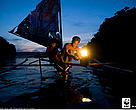 A local two man sailboat out for night fishing using a kerosine "Petromax" lamp to attract fish, Camarines Sur, Bicol, Philippines, Coral Triangle