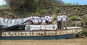 People standing on a barge-like boat.