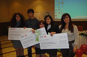 Winners of the essay competition holding HSBC cheques to implement their project proposals