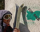 A person poses as a skier at a street action against illegal ski runs in Vitosha Nature Park