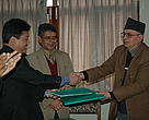Mr Anil Manandhar (left) shakes hands with Dr Ritu P Gartoulla (right) with Dr Wagle (centre) at the Project Agreement signing in Kathmandu on Friday, 9 February 2007.

