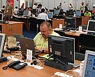 Brian Thomson at his computer, at the G8
