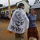 Sergio and Kuni with the WWF flag at a celebration commemorating the transfer of forest management rights from the federal government to a local forest community (COBA). Bevata, Madagascar © WWF / Cara Brook