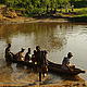 Ranto and some Malagasy porters crossing the river in a pirogue. Antaninary, Madagascar © WWF / Cara Brook