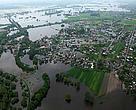 Flood retention walls lead to greater damage when breached.  Giving rivers room to flood and allowing wetlands to fulfill their function as natural wetlands reduces flood costs
