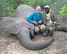 Dr Martin Tchamba (right) and Dr Mike Loomis pose beside the elephant which a few minutes latter charged on the team and injured Martin