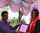 Mr. Anil Manandhar Country Representative, WWF Nepal handing over the plaque to Malina Joshi 