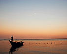 Fisherman docking his boat after sunset in the lower Myanmar Delta.