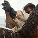 Jeff Phillips, Environmental Contaminants Coordinator for the U.S. Fish and Wildlife Service, rescues a Brown Pelican from the Barataria Bay in Grand Isle, La., June 4, 2010. State and federal wildlife services pulled approximately 60 Brown Pelicans, in the last two days, covered in oil from the Barataria Bay area. © U.S. Coast Guard / Petty Officer 3rd Class Ann Marie Gorden.