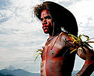 A Pukapuki resident in traditional dress. His headdress is made from the feathers of the Cassowary, Papua New Guinea's largest bird.