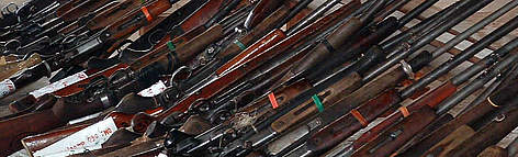 Confiscated poaching guns, Jengi, Cameroon / ©: WWF / Peter Ngea Row of guns lined up together. rel=