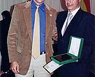 Mr. Roger Landivar, WWF Bolivia's Country Representative, receiving the award from Mr. Pablo Antelo, President of the Bolivian Forestry Chamber.