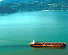 Freight ship clearing its bilge near Vancouver harbour, Canada, with the oil slick showing in the ship's wake.