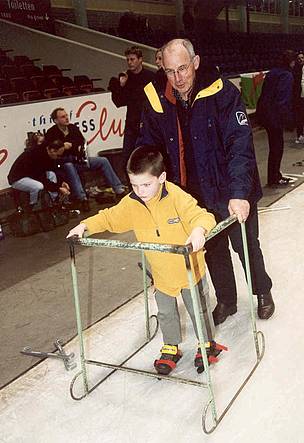 Henk Kroes teaches his son to ice skate.