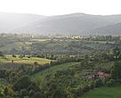 The mosaic landscape of the commune of Sinca Noua, with the Tagla Mountains in the background.