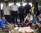 Mr. Anusit Kanjanapol (standing, centre) leads the Royal Thai Customs Officers team who confiscated 205kg of tiger, clouded leopard and panther carcasses which would have fetched US$17,650 on the black market.