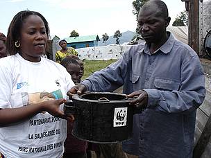 WWF staff member passing out an energy efficient stove in Eastern DRC. These stoves use less fuel ... / ©: Bruno Hugel / ©: Bruno Hugel
