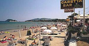 Bar sign using Loggerhead turtle (Caretta caretta) name with tourists sunbathing on beach in front, ... / ©: WWF-Canon / Michel GUNTHER Bar sign using Loggerhead turtle (<i>Caretta caretta</i>) name with tourists sunbathing ... / ©: WWF-Canon / Michel GUNTHER