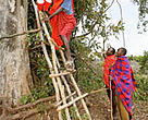 Farmers come down from a watch tower used to spot elephants, Transmara, Kenya.