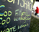 A beach-side fish shop selling fresh, sustainable, line caught cod, Aldeburgh, Suffolk, UK.