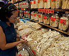 Shoppers looking at dried marine products like shark fins and dried abalone in Sheung Wan District, Hong Kong.