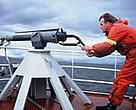 Norwegian whaler demonstrating a harpoon gun.