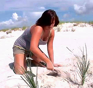 A student from the WWF Allianz Southeast Climate Witness project plants trees on the beach.